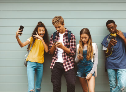 teenage friends looking at their mobile phones