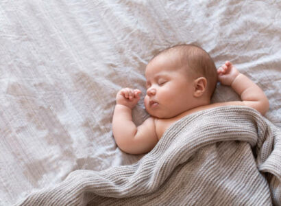 peaceful baby lying on a bed and sleeping at home