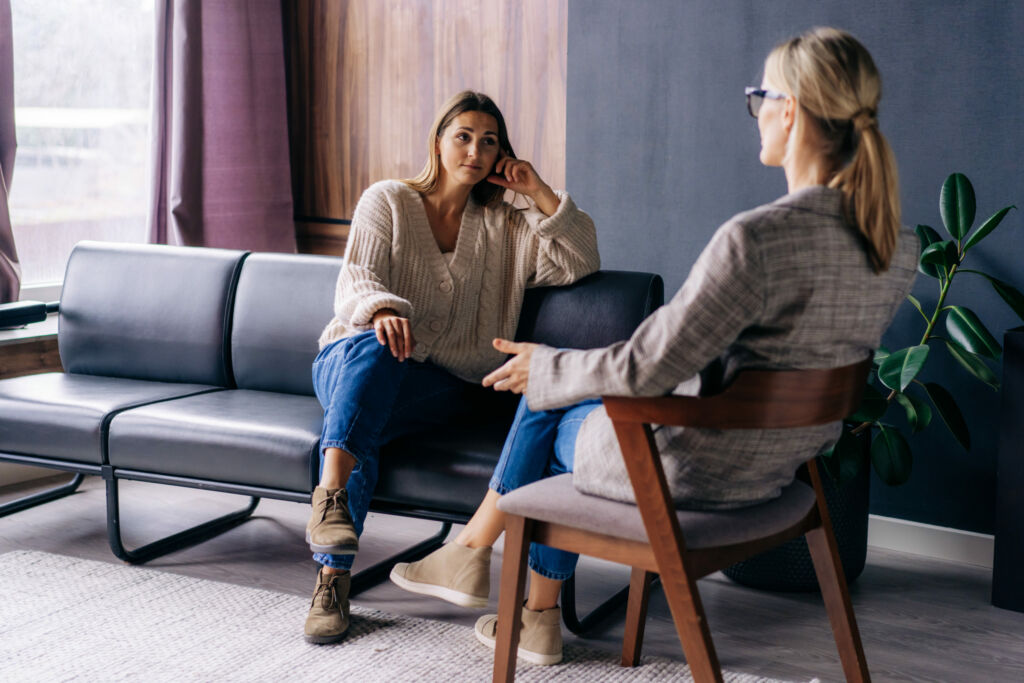 a young woman in a consultation with a psychologist listens to advice on improving behavior in life.